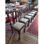 A set of four George III style mahogany dining chairs, the shaped top rails over pierced vase