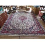 A Sarouk design carpet, the central red medallion in an ivory field filled with foliate designs in a