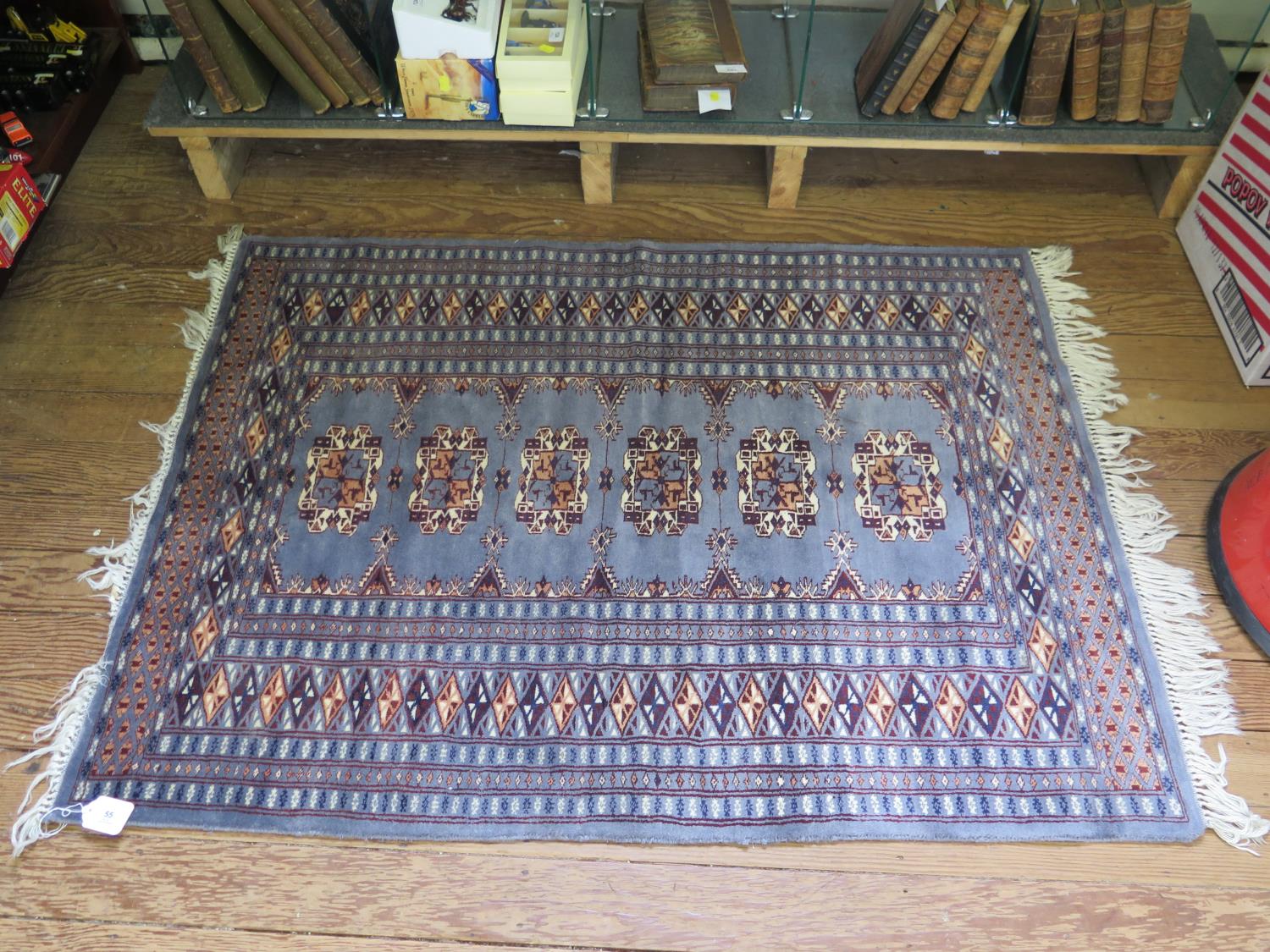 A Bokhara rug, with a single row of six guls within a multiple border, 140 x 93 cm