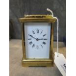 A brass carriage clock timepiece, of conventional form, with enamelled dial, single train