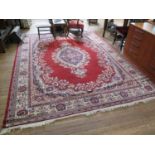 A Keshan style carpet, European made, the blue floral central medallion on a red field with blue