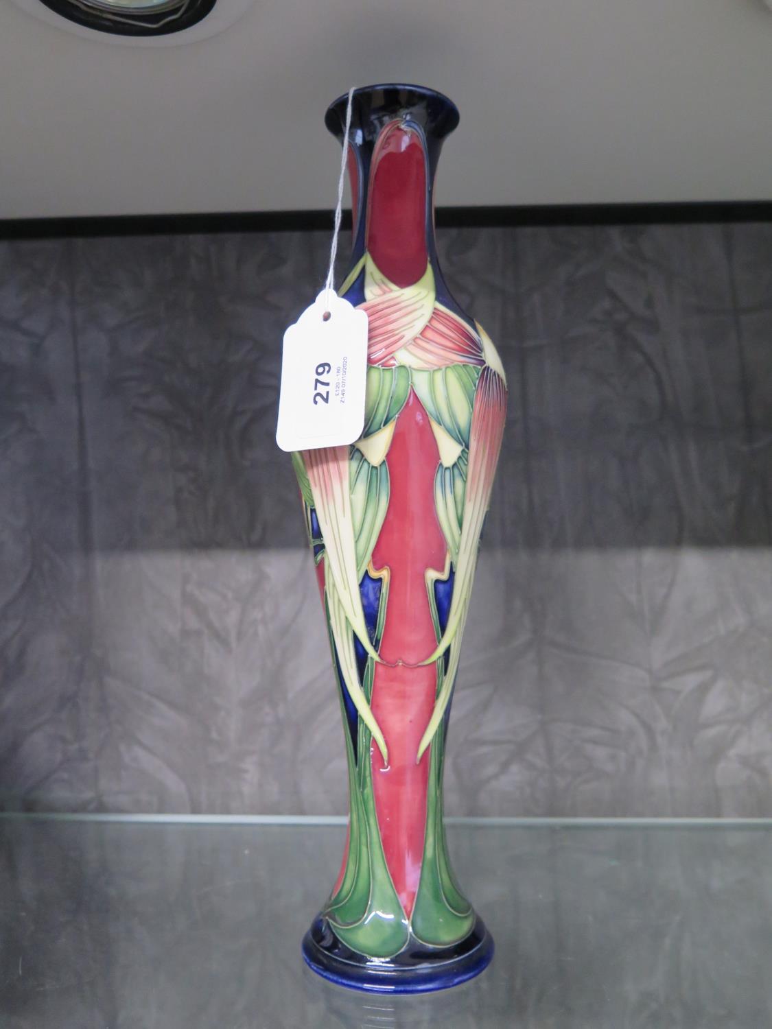 A Moorcroft Pottery slender Trinity pattern vase, signed by Philip Gibson and numbered 266, 31.5