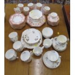 An Edwardian Wedgwood part tea service, of octagonal form with red foliate swag decoration, and a