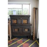 A heavily carved oak bed frame, with inlaid panels depicting birds among foliage, within gadrooned