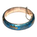 A Far Eastern bangle finished with blue enamel