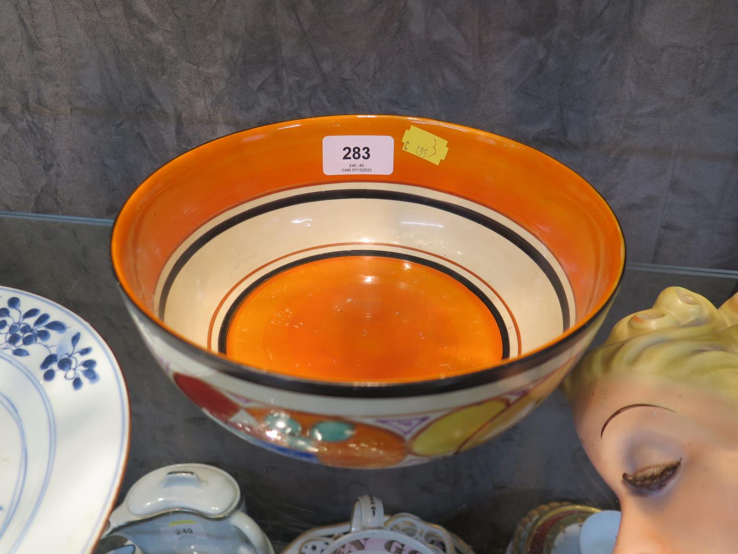 A Clarice Cliff Fantasque bowl, painted with stylised fruit, 19.5 cm diameter