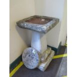 A reconstituted stone bird pool, of square form, 36 cm square, 61cm high, and a circular plaque