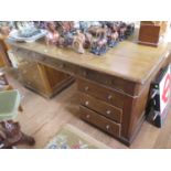 An early 20th century oak partner's desk, one side with three frieze drawers over three drawers in