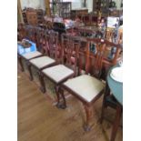 A set of five George III style mahogany dining chairs, the shaped top rails over pierced vase