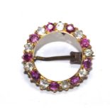 A ruby and diamond circular brooch