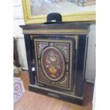 A late 19th century ebonised pietra dura side cabinet, with gilt metal mounts, the single panelled