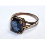 A 9 carat gold ring set with faux sapphire