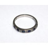 An eleven stone sapphire and diamond half eternity ring set in 18 carat white gold