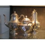 A Continental silver coloured metal tea set consisting of a coffee pot, tea pot and a lidded sugar
