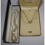 A bag with two pearl necklaces with 9 carat gold clasps and a cultured pearl necklace with 14