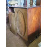 An early 19th century mahogany cabinet, converted to a TV cabinet, with twin oval panelled doors