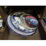 A large pottery charger with profusely hand painted decoration, 36cm diameter, another smaller and