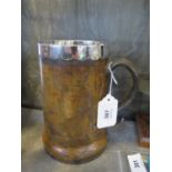 A leather tankard with a silver plated liner, 18.5cm
