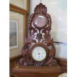 A Victorian walnut table top barometer and timepiece, the foliate scroll and husk carved frame