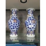 A pair of Chinese blue and white baluster vases, with gilt highlights and enamelled floral