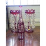 A pair of Victorian red overlay glass lustres, with prism shape pendants, 31.5 cm high, and a