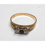 A three stone sapphire and diamond ring set in gold