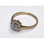 A 9 carat gold ring set with faux diamonds