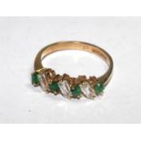 A seven stone ring set with emeralds and cubic zirconia