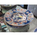 A pair of Chinese blue and red dishes, the centres depicting a pagoda, a bridge and trees, within