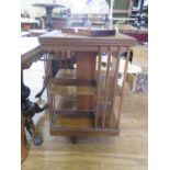 A walnut revolving bookcase, of square form with pot castors, 53 cm square, 81 cm high