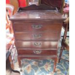 An Edwardian stained beech music cabinet, with four fall-front drawers on square legs, 50.5 cm wide,