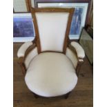 An Edwardian inlaid armchair, the scroll inlaid top rail with burr walnut, over upholstered arms,