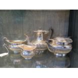 An Edwardian four piece silver tea and coffee set, with gadrooned sides, coffee pot 19 cm high,