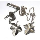 Two silver leaf pendants on chains