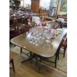 A twin pedestal dining table, made of 19th century parts, the rectangular top with two extra