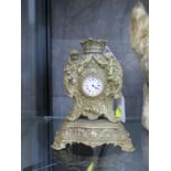A gilded mantel clock with ladies fob watch movement together with two napkin rings, silver