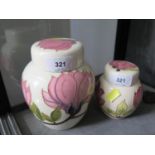 Two Moorcroft Pottery Magnolia design ginger jars and covers, each with a cream ground, 15 and 10.