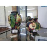 A Moorcroft Pottery Queen's Choice pattern baluster vase, 16 cm high, and a globular vase in the