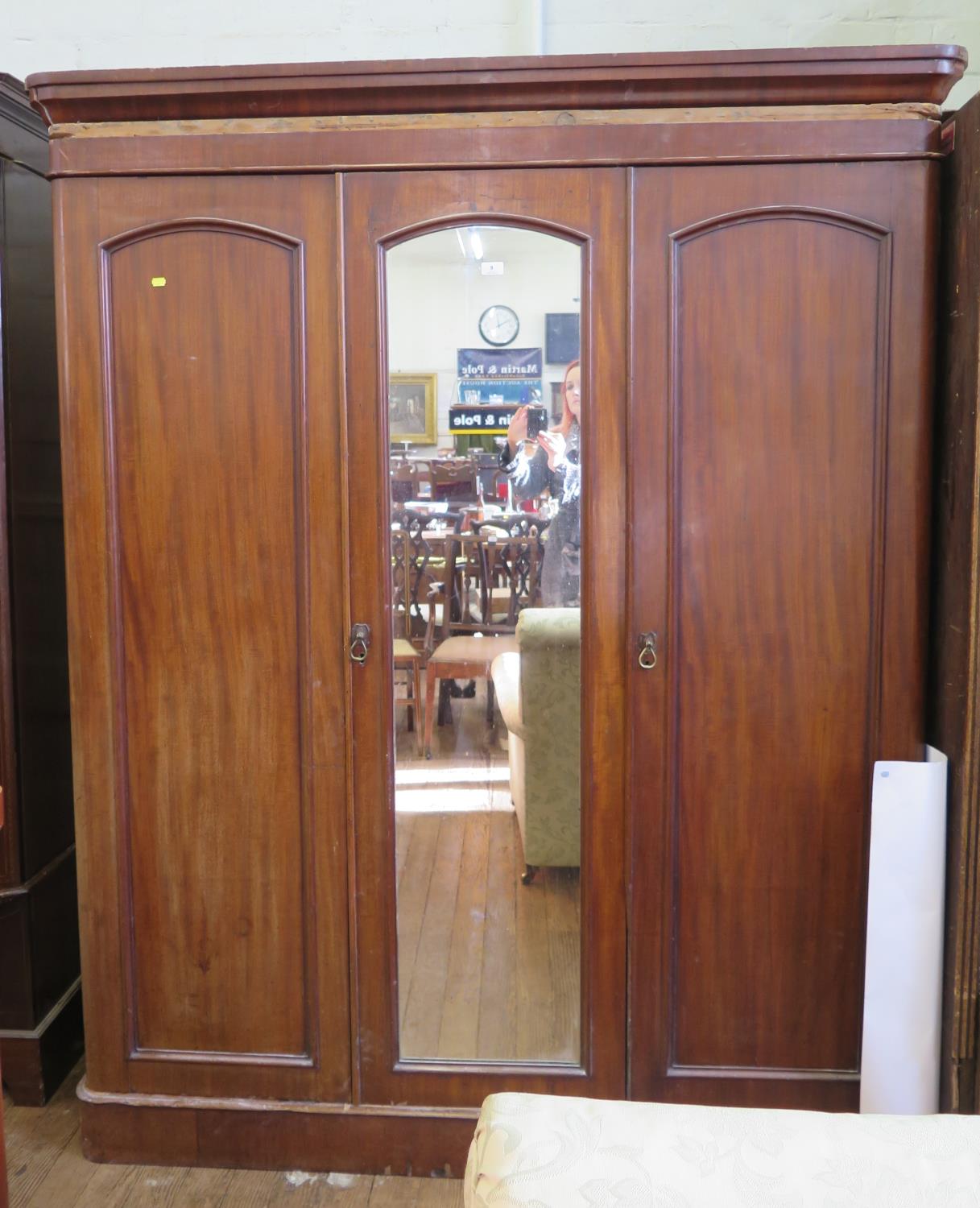 A Victorian mahogany three door wardrobe, with central mirrored door on a plinth base, 167 cm