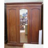 A Victorian mahogany three door wardrobe, with central mirrored door on a plinth base, 167 cm