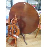 A George III style mahogany tripod table, the circular top on a baluster stem with cabriole legs and