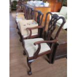 A set of four George III style mahogany dining chairs, the shaped top rails over pierced vase