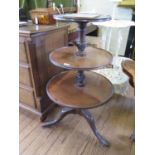 A George III mahogany three tier whatnot, the dished circular tiers on gadrooned turned stems and