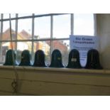 A set of six green glass bell shape lamp shades, 14.5 cm high