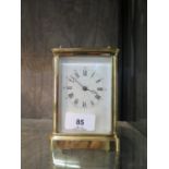 A brass carriage clock timepiece, of conventional form, with enamelled dial, single train