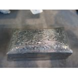 A white metal box decorated in relief and signed to the inside of lid, 12 cm wide