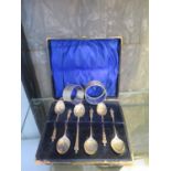 Six silver Apostle coffee spoons, in a case, and two silver napkin rings