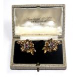 A pair of gold colour earrings, each having a rose diamond and a ruby cluster, in fitted box