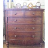 A Victorian mahogany bowfront chest of drawers, with two short and three long drawers on turned
