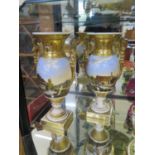 A pair of early 19th century gilt decorative vases, with angel twin handles, hand painted with river